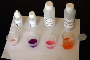 Control tests using the sodium rhodizonate solution (on the right). The second to the right shows pink color when the test solution is added to a neutral solution of lead nitrate. It turns purple (second from left) in an acidic solution that contains lead. It produces a white precipitate in a solution basic solution of lead. In the soil samples, lead in acidic soil produced a blue color. When a base was added, a black precipitate formed. All samples with lead present were also highly acidic.