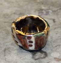 Raku pot using copper oxide glaze, which reduced to a copper metal shine.