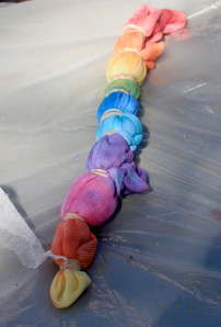 Method for making a bulls-eye pattern. The center is pulled up while the shirt is twisted slightly, then bound in sections by rubber bands and dyed.