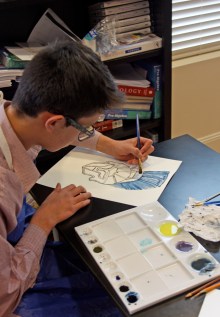 Sebastian painting Greek armor using Prussian blue and cobalt blue with carbon black pigment he made.