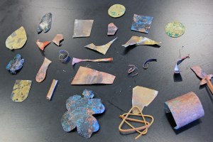 Shapes cut from sheets of copper and brass, treated with vinegar and salt (green patina) and ammonia and salt (blue patina).