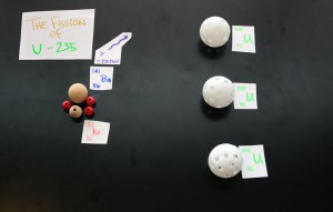 The first atom of U-235 splits into Barium and Krypton plus energy and two additional neutrons.