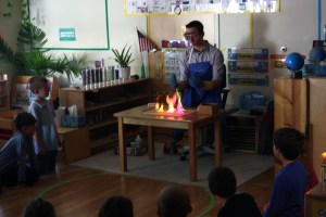 Evan demonstrates the colors of salts in methanol flames for a kindergarten class. Note: We were careful to follow safety precautions and use only small amounts of methanol, keeping the bottle well away from the flames.