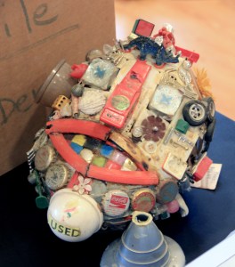 This is Herbie the Head, my first junk sculpture. It's a bit the worse for time. The frame is made of welded plastic girders. The neck and support are the rocket nozzle and heat shield of an Apollo space capsule.