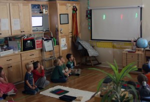 A laser light show, made by bouncing laser beams off of mirrors attached to the woofers of stereo speakers.