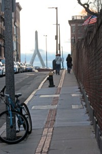 Over the hill past Cobb's Hill Burial Ground. A pylon of the new Zakim-Bunker Hill bridge is visible.