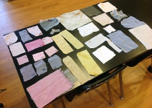 Finished swatches after dyeing and drying. The pink is cochineal, yellow is rabbitbrush, even tan is walnut, and uneven tan is sunflowers. Undyed cloth is also shown for a control.