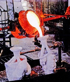 Pouring the molten bronze into the pre-heated ceramic/cement molds.