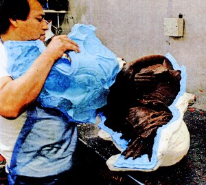 Removing the silicon rubber from the wax positive.