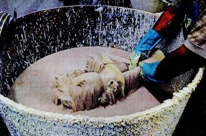 Coating the slurry in sand. Air blown up through the sand to make it easy to coat the slurry.